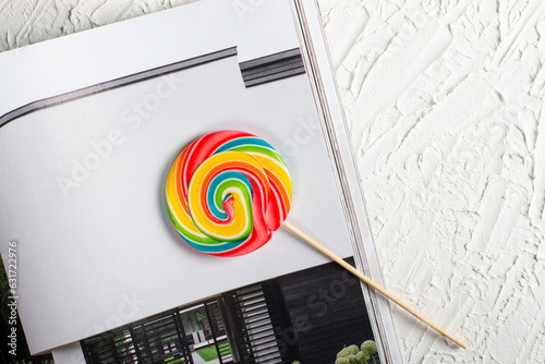 Bright multicolored lollipop on a white background. top view. sweets for the holiday. There is an empty space on the right for placing text or something else.