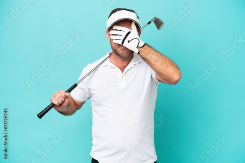 Middle age caucasian golfer player man isolated on blue background covering eyes by hands. Do not want to see something