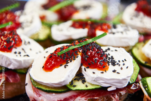 camembert cheese with jam and seeds on toast with Iberian ham and zucchini photo