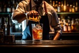 Professional bartender pouring and preparing cocktails at bar counter. Details of mixology