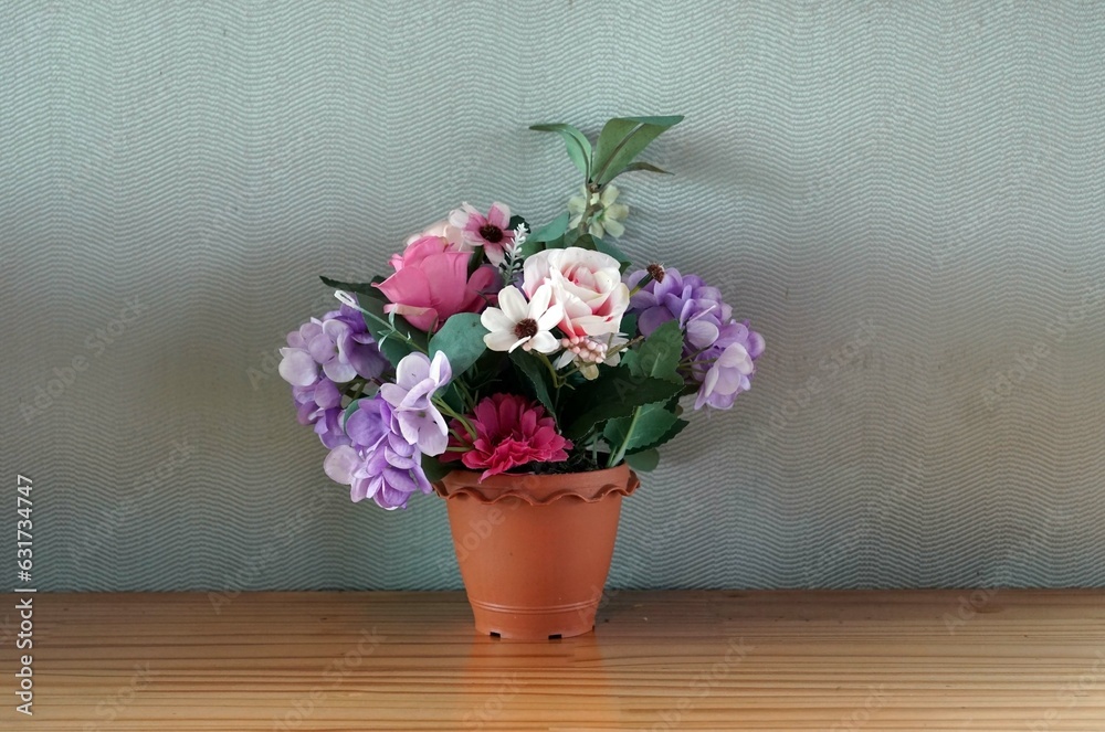 A flowers in a vase on a wooden table in the cafe, decoration concept. A flowers in a vase on a wooden table in the cafe, decoration concept.