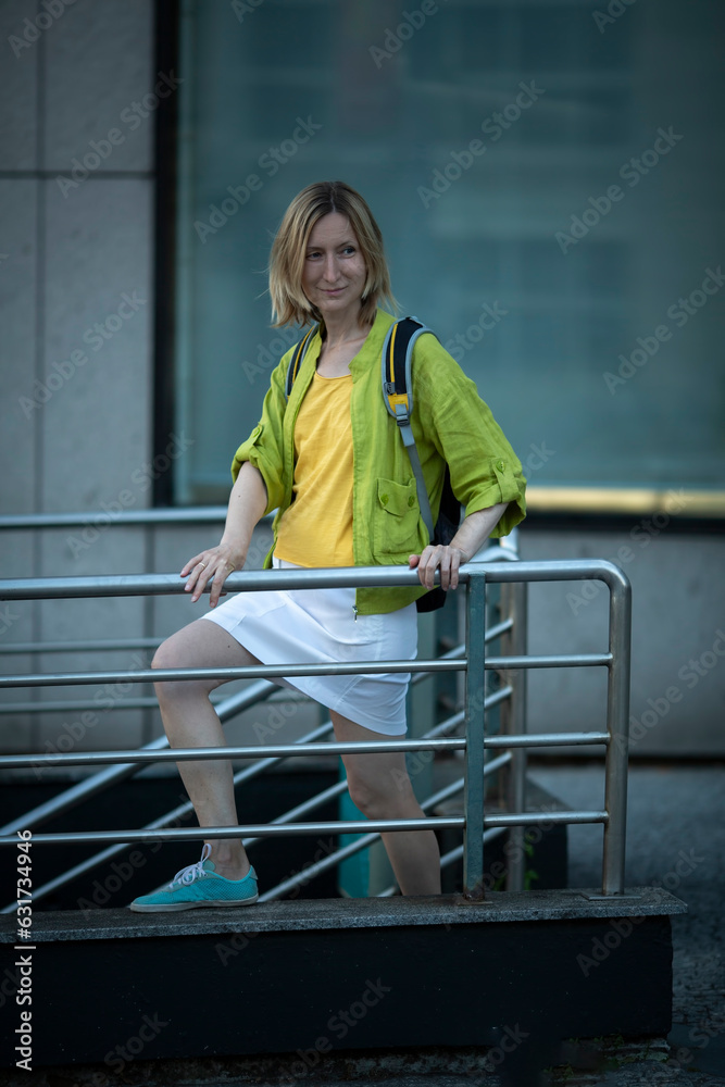 A woman near the underpass hurries to meet her destiny.