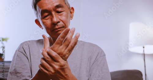 An Asian man has tingling and numbness in his hand which causes beriberi. photo