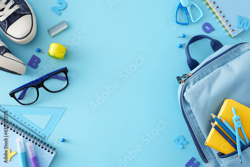 Set for elementary school concept. Top view photo of stylish shoes, child's bag, glasses, school stationery, blue letters on pastel blue background with empty space for promo or text