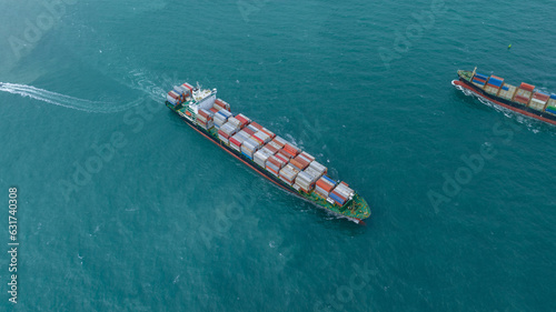 Aerial in front view of Two 2 Large Cargo Ship carrying container and running in Opposite direction for export import Cargo at sea sunset ocean concept technology transportation logistics