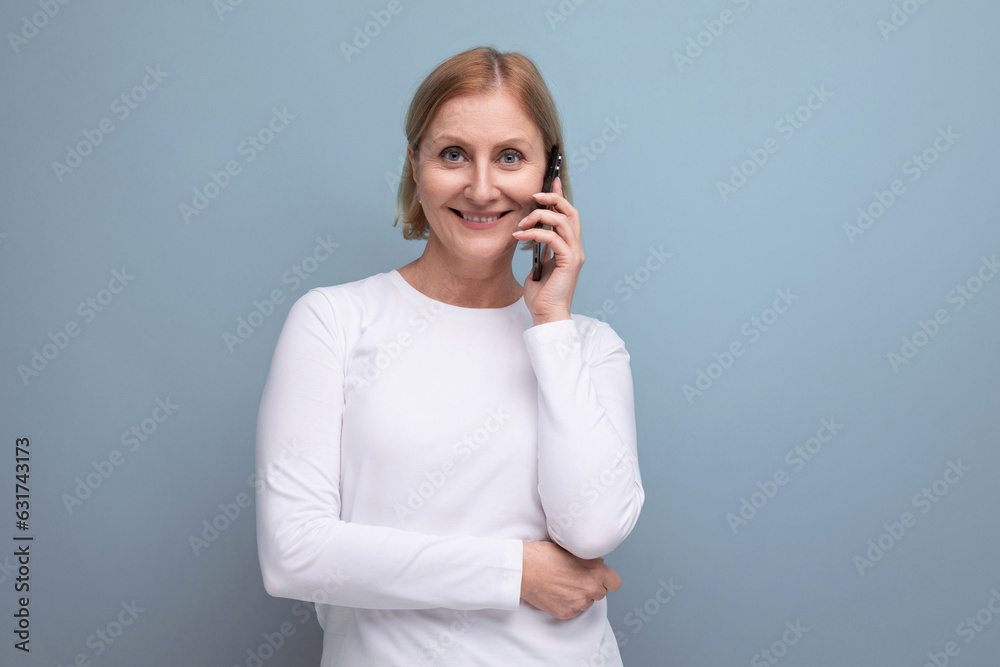 cute blonde middle aged woman chatting on the phone cute blonde middle aged woman chatting on the phone