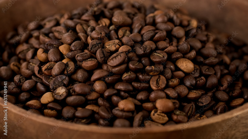 Coffee beans in wooden bowl, close up