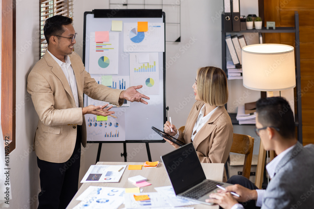 Group of confident business people point to graphs and charts to analyze market data, balance sheet, account, net profit to plan new sales strategies to increase production capacity. Group of confident business people point to graphs and charts to analyze market data, balance sheet, account, net profit to plan new sales strategies to increase production capacity.