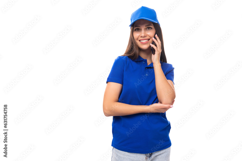merch design concept. smiling young woman in blue cotton t-shirt and cap talking on the phone merch design concept. smiling young woman in blue cotton t-shirt and cap talking on the phone