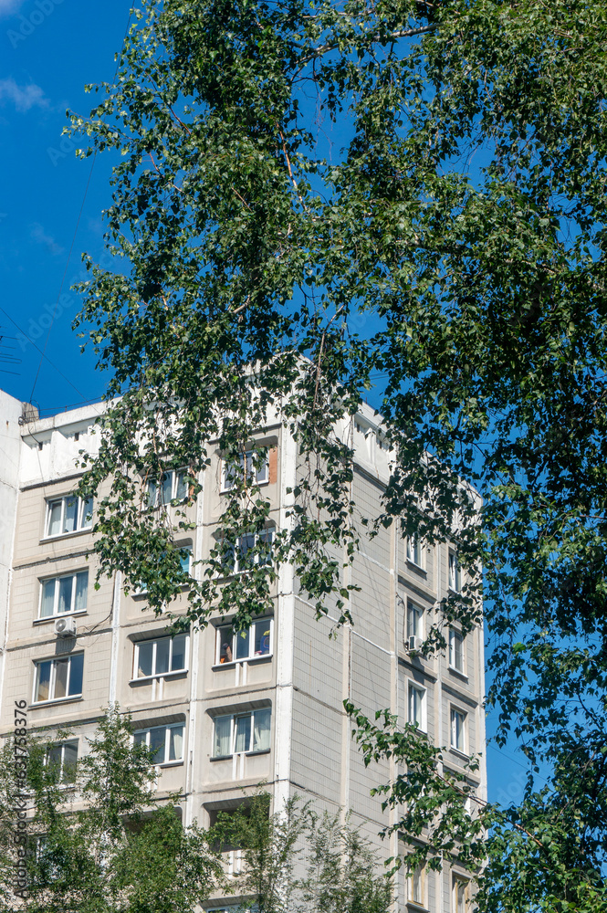 Facade of a modern apartment building on a background of blue sky Facade of a modern apartment building on a background of blue sky