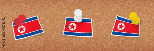 North Korea flag pinned in cork board, three versions of North Korea flag.