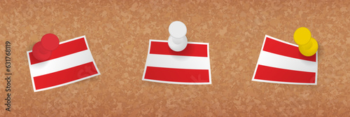 Austria flag pinned in cork board, three versions of Austria flag.