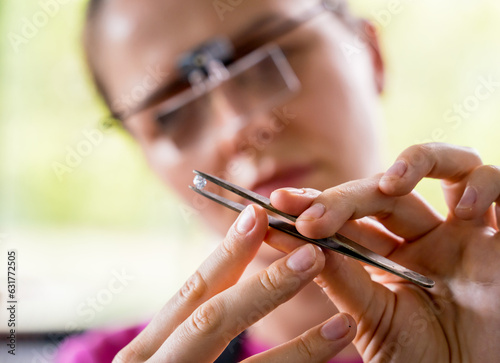 Young female jeweler making jewelry in workshop