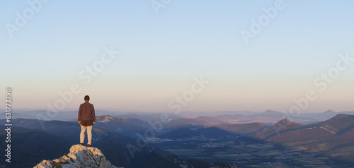 Man at sunset in the Sierra de Aralar with the mountains of Navarra in the background.