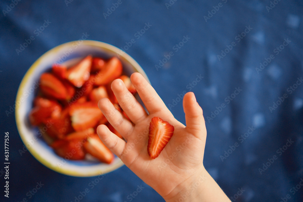 Children's hand and strawberry Children's hand and strawberry