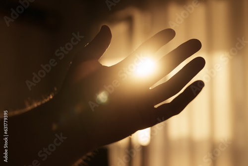 Konstfotografi Abstract man hand playing with sunset light indoor