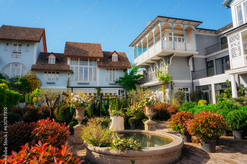 Fototapeta premium Traditional house with a carved wooden balcony in the garden. Tbilisi, Gerogia. High quality photo