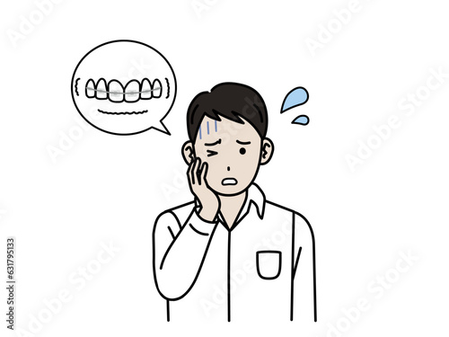 ワイヤー矯正で歯が痛む若い男性