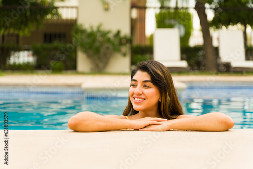 Relaxed attractive woman relaxing in the resort pool