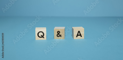 wooden cubes with Q&A written on them on light blue background concept image