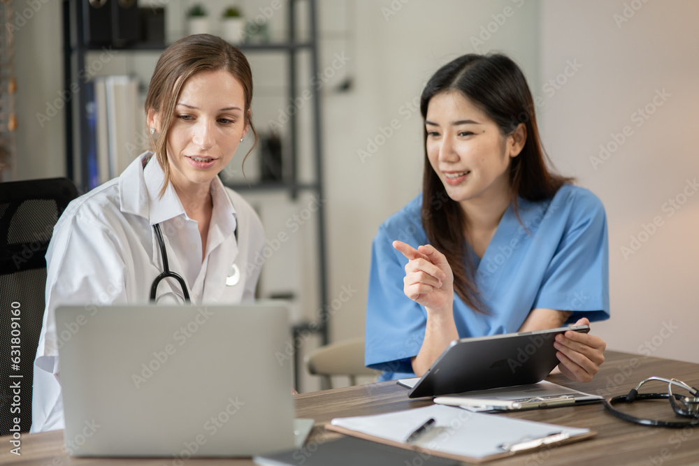 female doctor consulting with a female nurse at the clinic at the hospital female doctor consulting with a female nurse at the clinic at the hospital