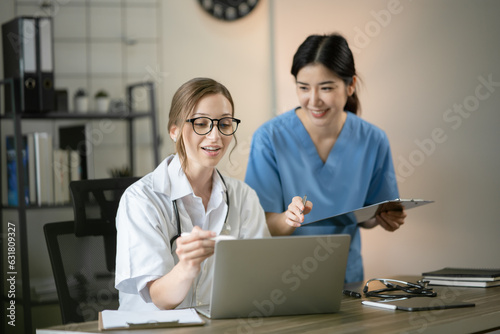 female doctor consulting with a female nurse at the clinic at the hospital