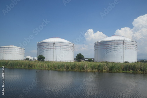 Giant tank for oil storage, which is on the edge of the river