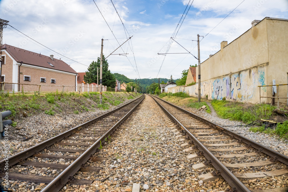A view of the railway tracks leading with an old house station, Czech