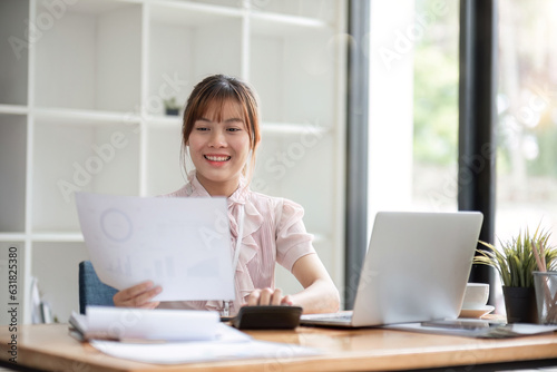 Asian Businesswoman Using laptop computer and working. Businesswoman doing accounting analysis report investment data, Financial at office