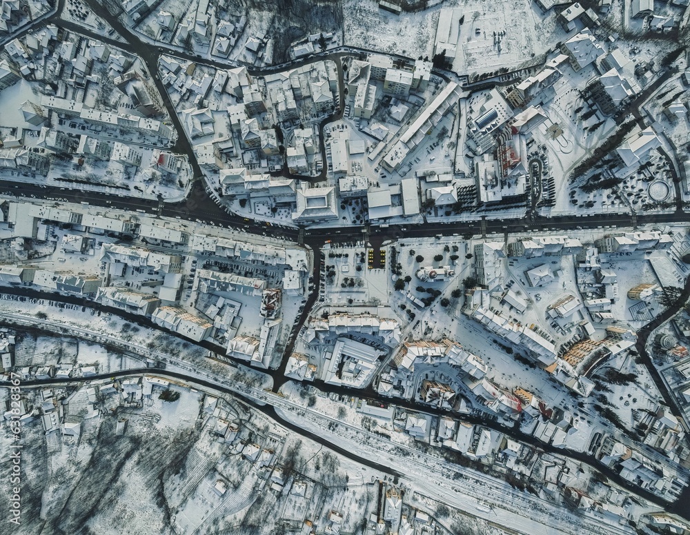 Aerial top view of streets and buildings covered with snow in winter Aerial top view of streets and buildings covered with snow in winter