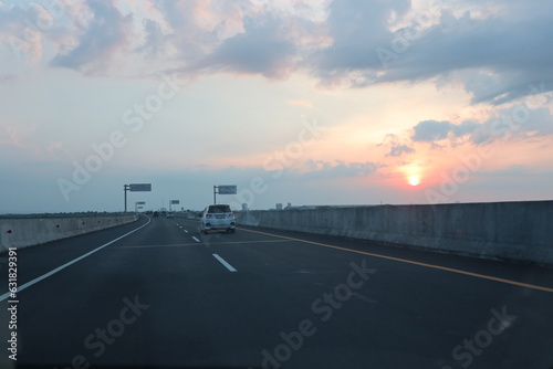Picturesque landscape scene and sunrise above road © Mahfudh