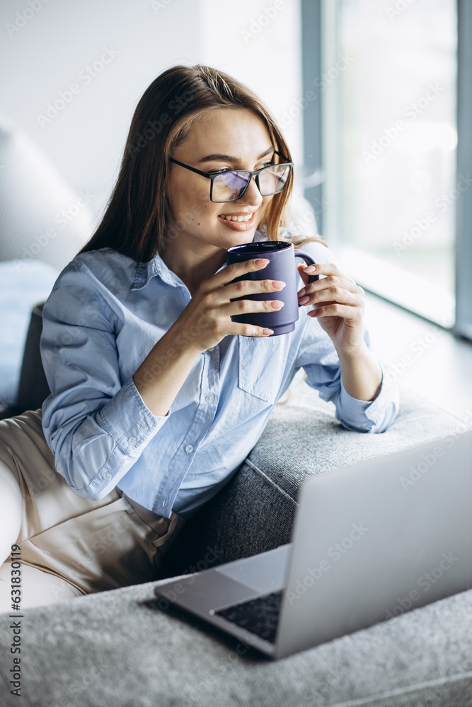Business woman working on laptop and drinking coffee Business woman working on laptop and drinking coffee