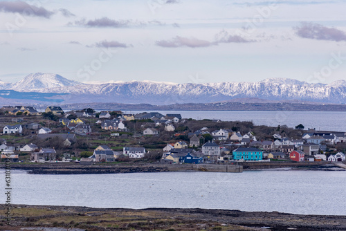 Distant panoramic view with snowy mountains on the background of Kilronan, Inishmore island, Galway, Ireland