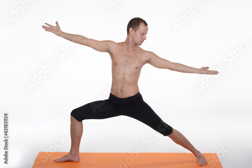 Man doing yoga in photo studio on isolated background.  © AkosHorvathWorks