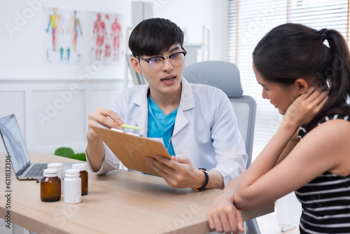 Asian young Doctor talking to woman patient at the clinic or hospital.