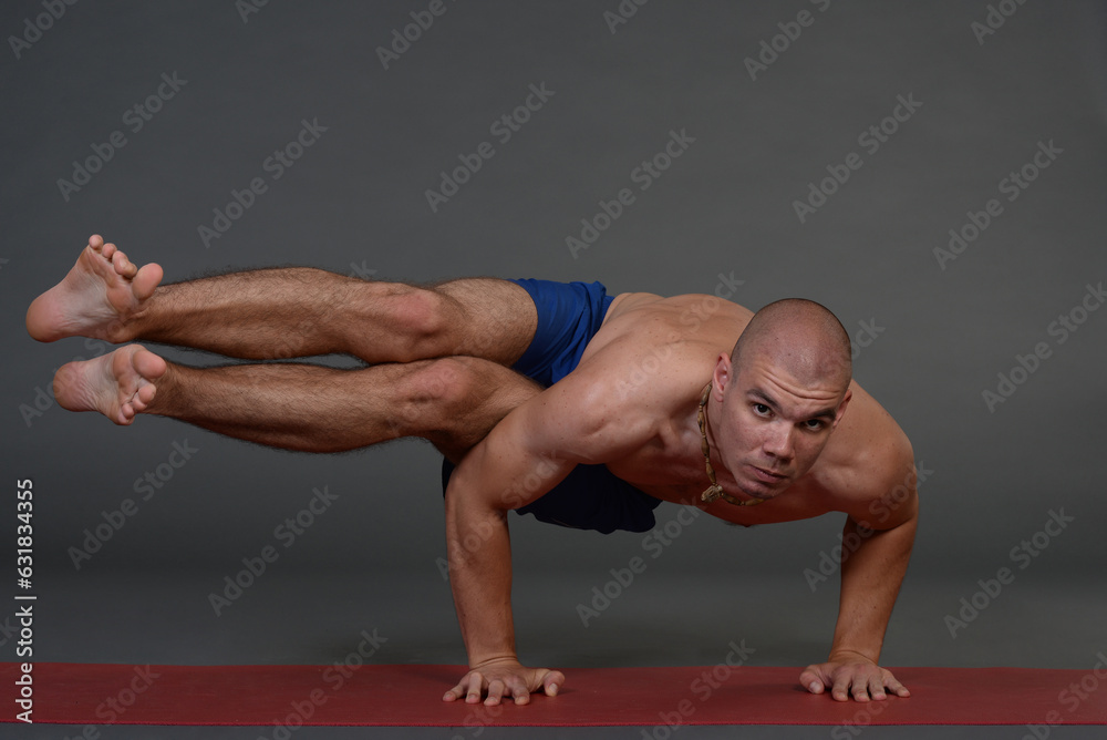 Man doing yoga in photo studio on isolated background. Man doing yoga in photo studio on isolated background.