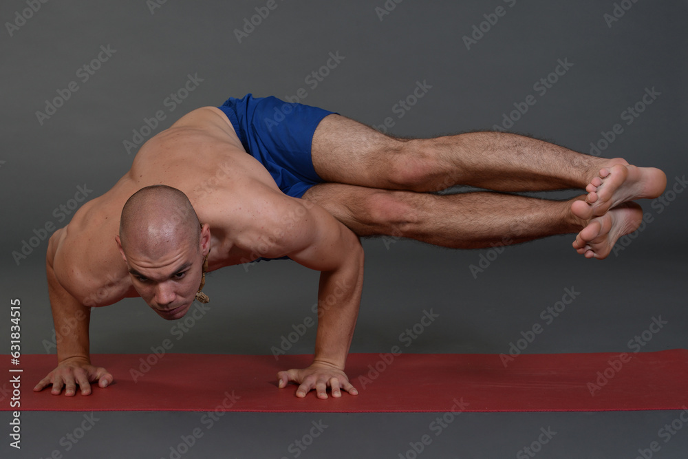 Man doing yoga in photo studio on isolated background. Man doing yoga in photo studio on isolated background.
