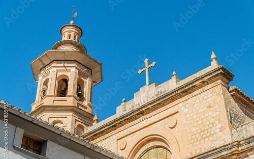 Bell tower and church against blue sky in Xaló (Alicante, Spain)