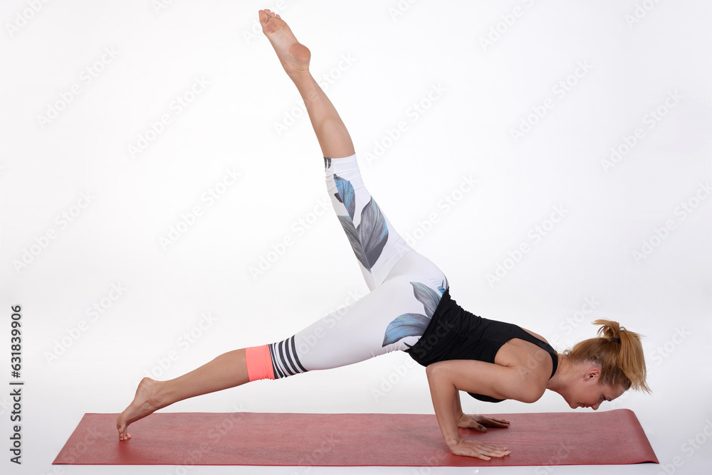 Naklejka premium Woman doing yoga in photo studio on isolated background.
