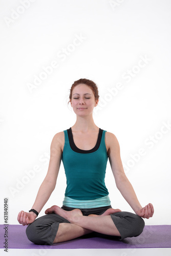 Woman doing yoga in photo studio on isolated white background. 