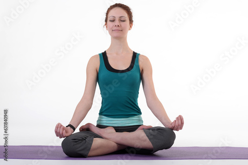 Woman doing yoga in photo studio on isolated white background. 