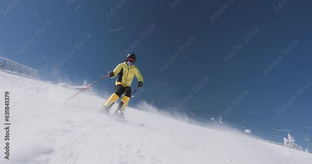 Experienced professional skier skiing on slope on a sunny winter day. Recorded on cinema camera at 120fps. Ski run 02 clip 2 of 3. Experienced professional skier skiing on slope on a sunny winter day. Recorded on cinema camera at 120fps. Ski run 02 clip 2 of 3.