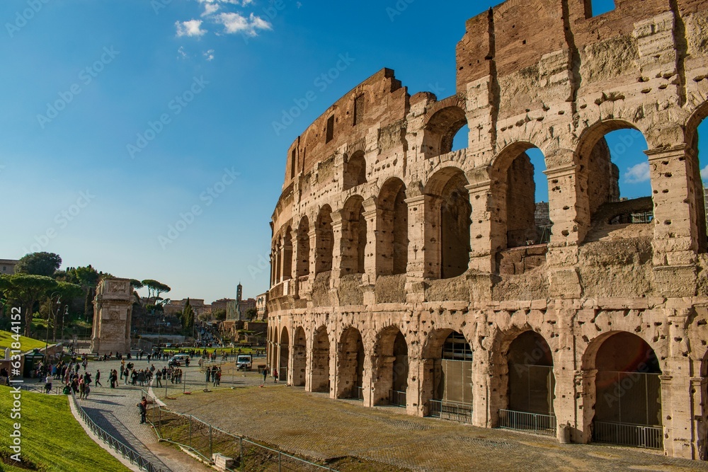 Vertical shot of a crowd of tourists gathered around the Colosseum in Rome, Italy