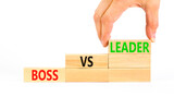 Boss vs leader symbol. Concept words Boss vs versus leader on wooden block. Beautiful white table white background. Businessman hand. Business motivational boss vs leader concept. Copy space.