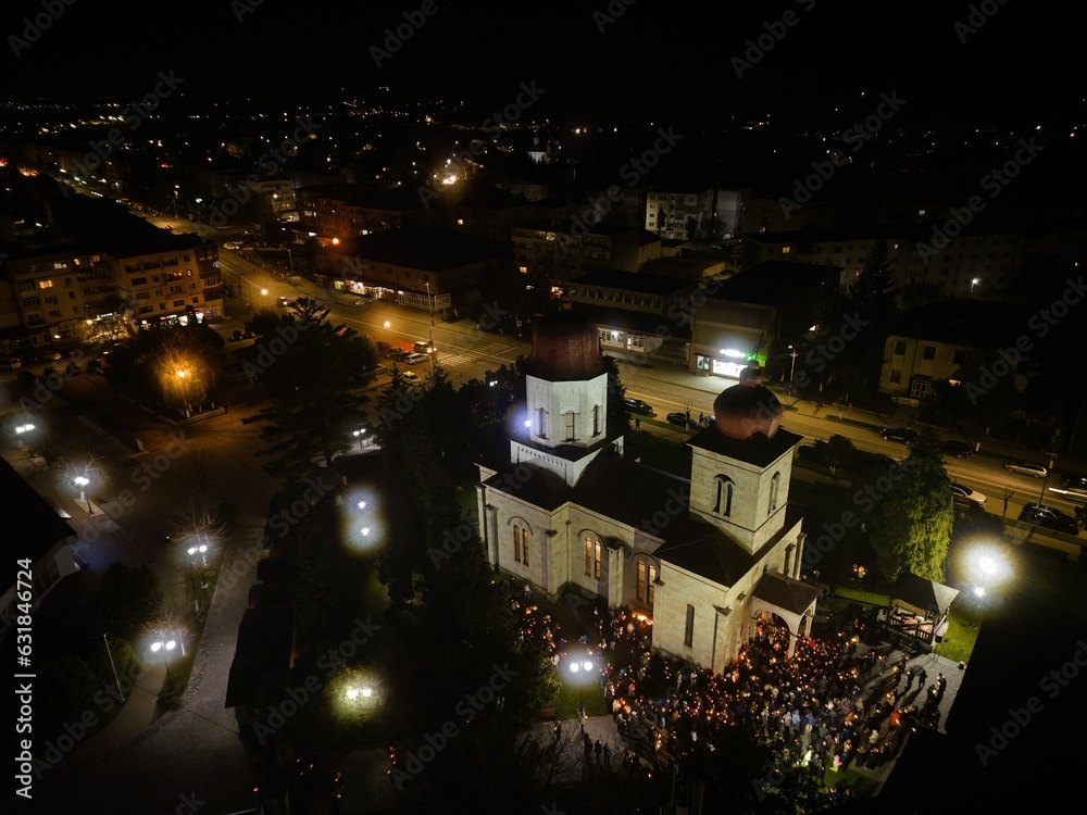 Aerial view of a church with people gathered in the yard