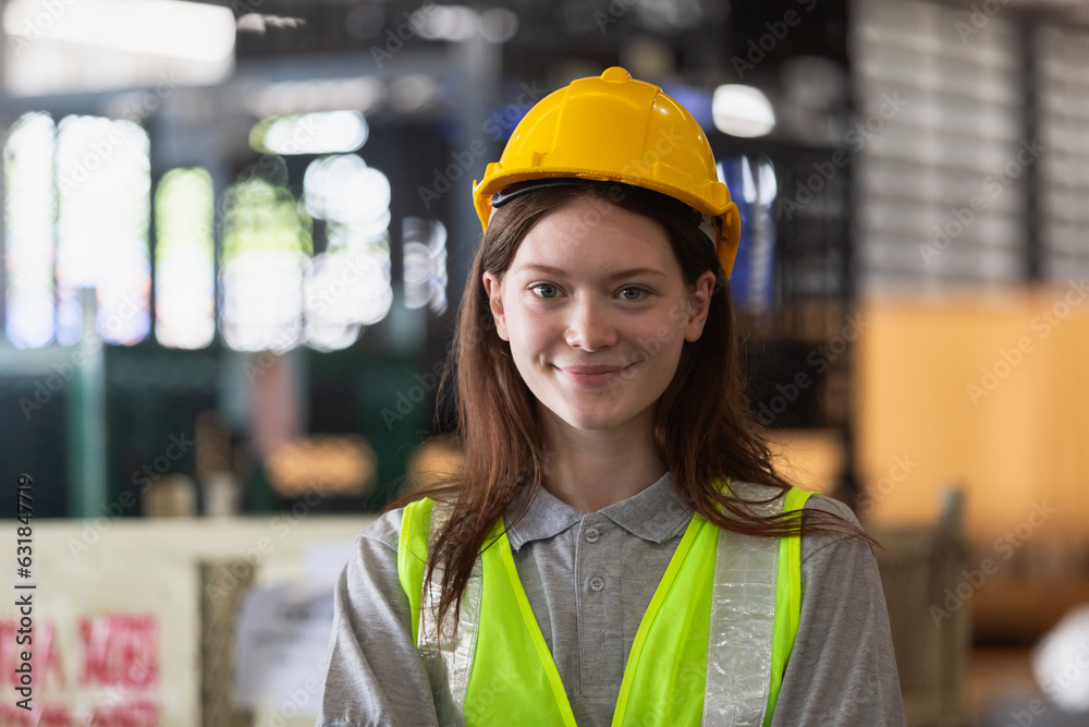 portrait of woman wearing safety uniform looking at camera standing in warehouse factory. Female professional worker check stock inspecting goods on shelves in warehouse. portrait of woman wearing safety uniform looking at camera standing in warehouse factory. Female professional worker check stock inspecting goods on shelves in warehouse.