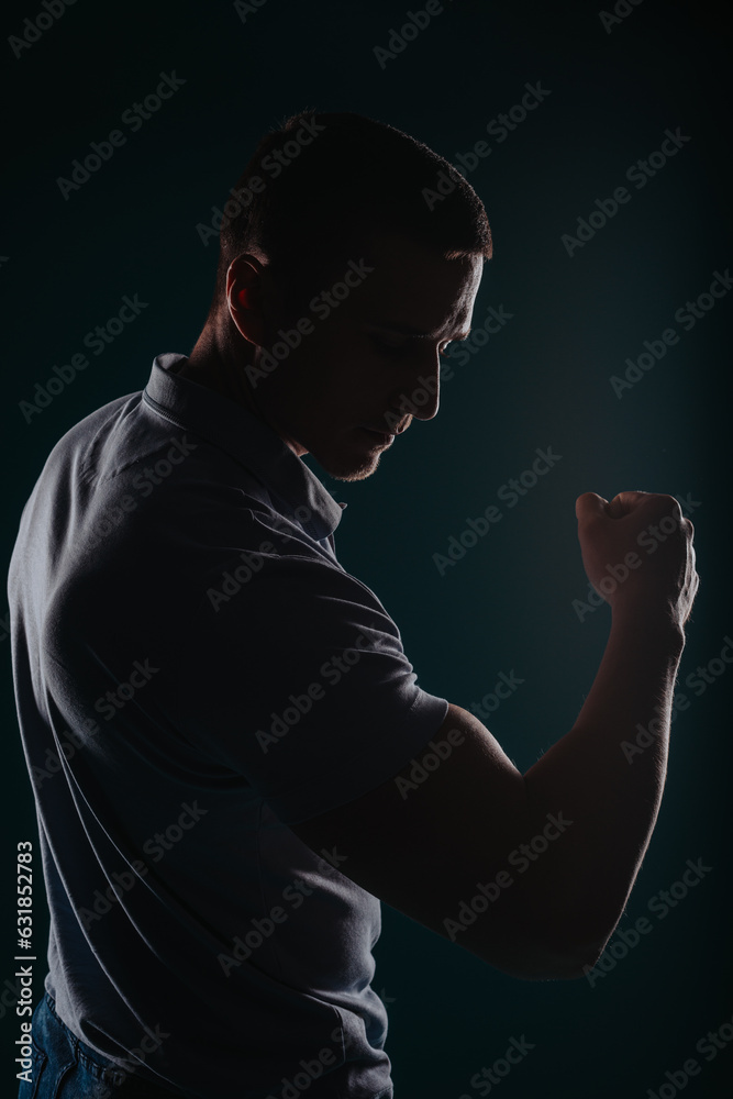 Handsome and muscular man flexing his bicep