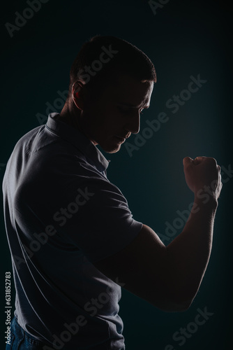 Handsome and muscular man flexing his bicep © qunica.com