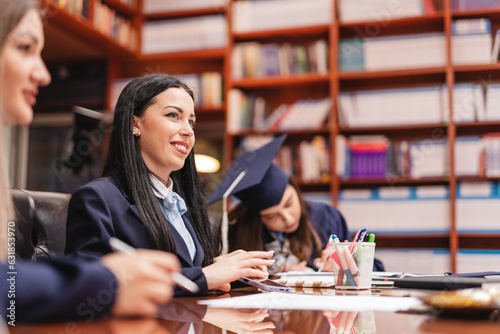 Group of faculty students writing graduation forums