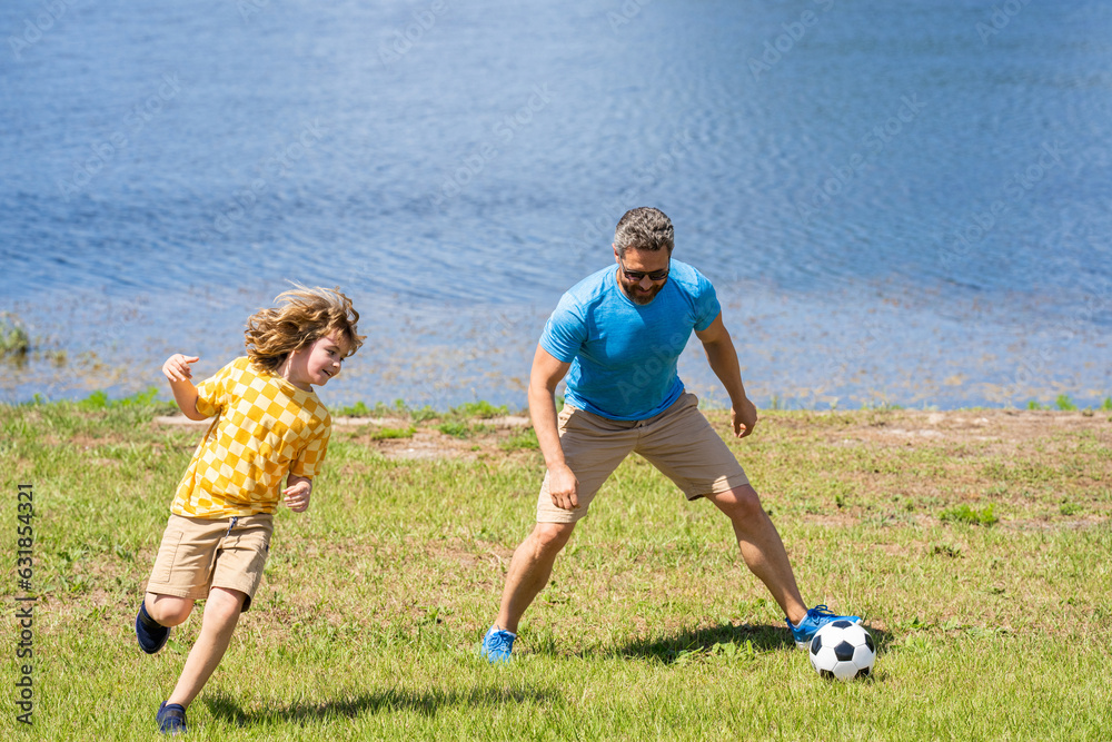 dad have fun with his son. dad and son enjoying childhood adventures outdoor. dad and son playing football during their childhood. Childhood memories of son and his dad. creating lasting memories dad have fun with his son. dad and son enjoying childhood adventures outdoor. dad and son playing football during their childhood. Childhood memories of son and his dad. creating lasting memories